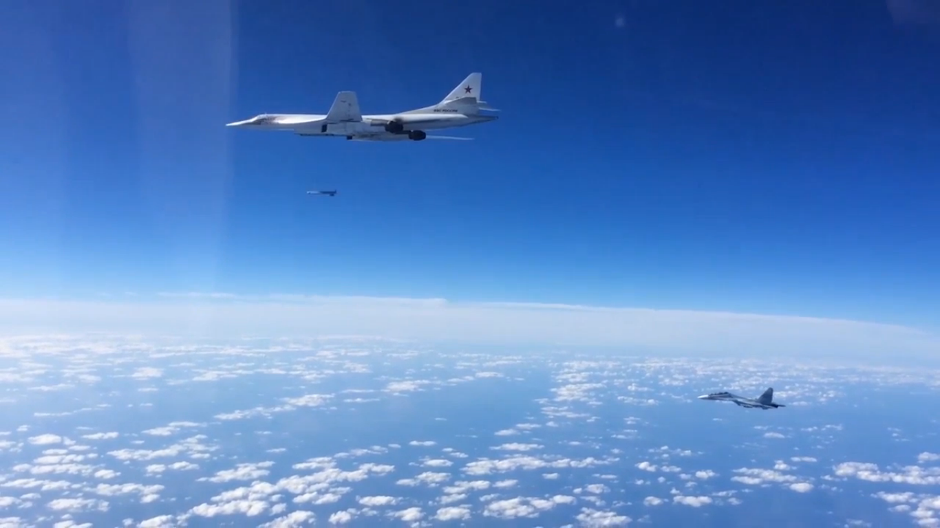 A Su-30SM following a Tu-160 to observe a missile launch.