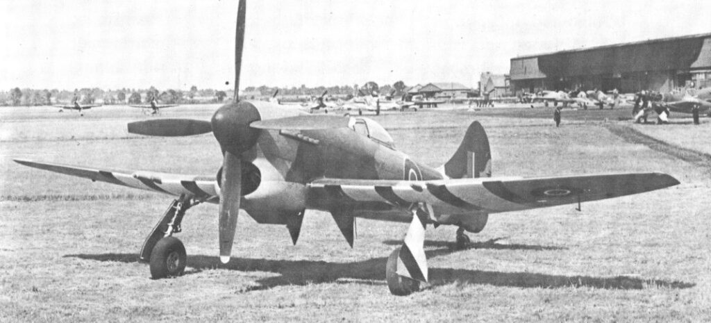 A Hawker Tempest V parked on the grass in black and white.