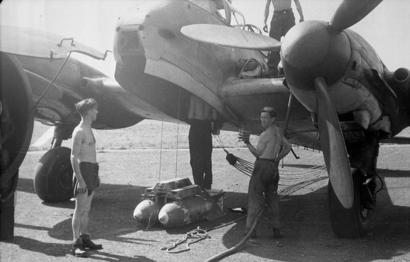 An Me 210 being re-armed by engineers in the field.