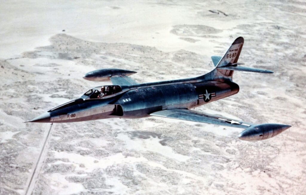 An XF-90 in flight over the desert.