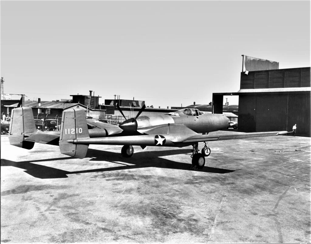 XP-54 parked outside a hangar.