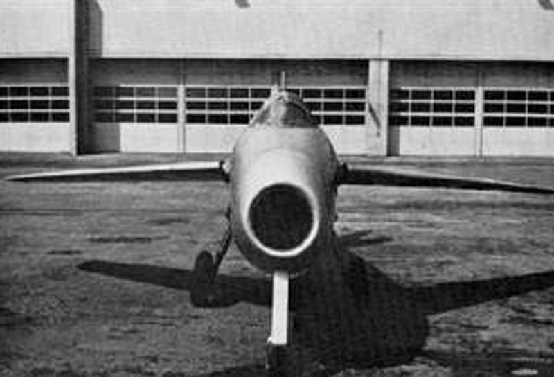 P.1101 head on parked outside of a hangar.