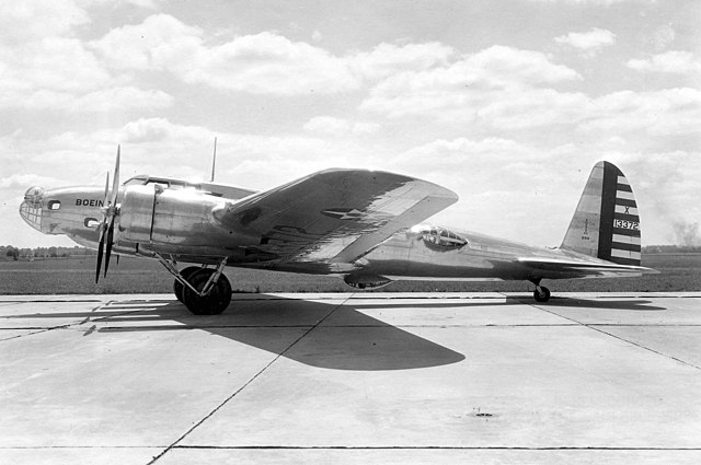 A side view of the Boeing model 299 parked on a runway.