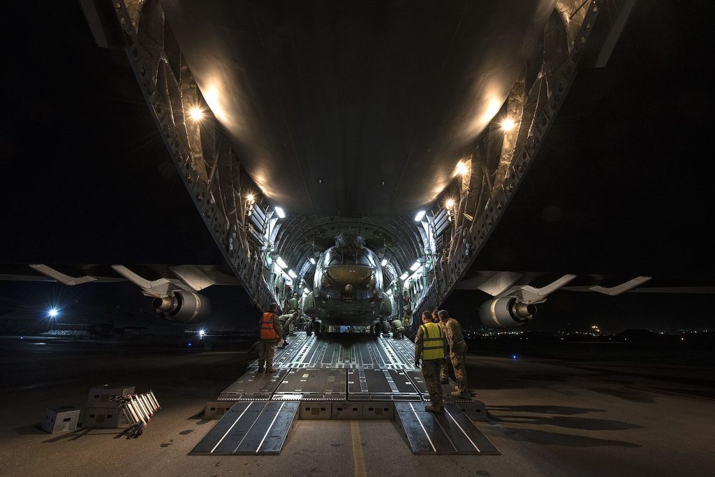 An RAF C-17 loading a Chinook helicopter.