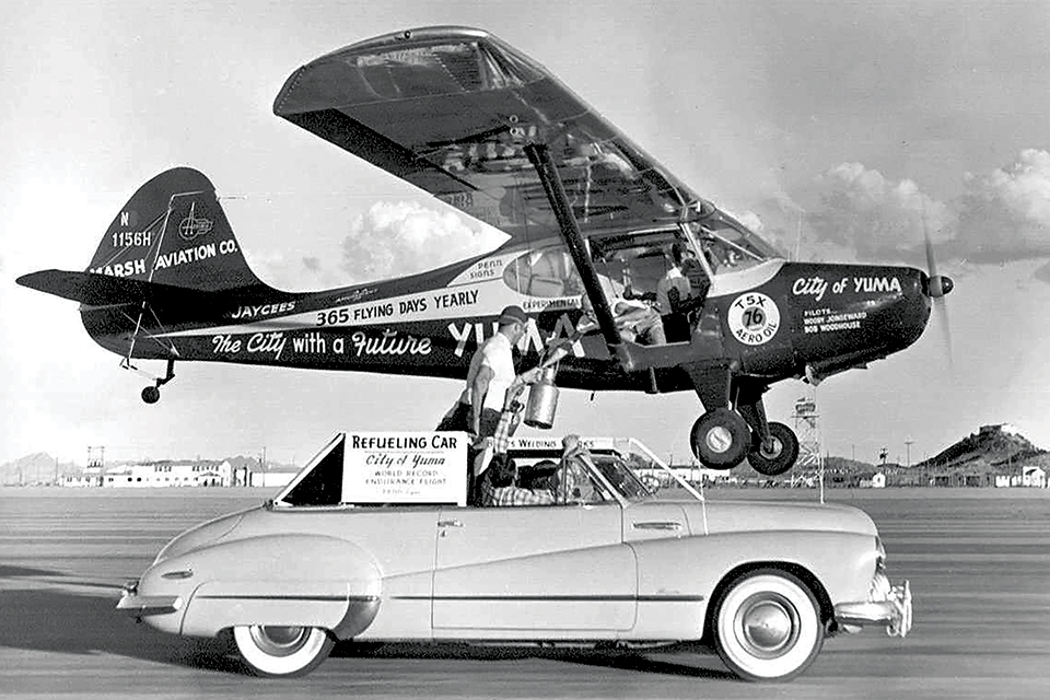 The Aeronca Sedan City of Yuma takes on supplies from a Buick in 1949. Photo credit - Yuma Daily Sun