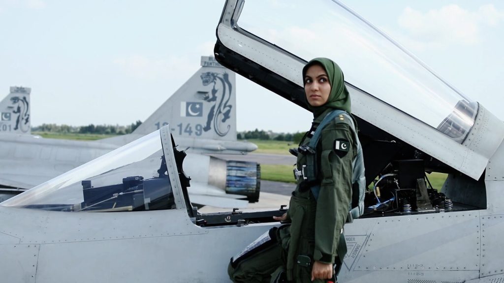 A female Pakistani fighter pilot stepping into the cockpit of her JF-17.