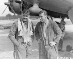 Capt. Clark Gable (left) and co-pilot Lt. Col. Robert W Burns, both of the Boeing B-17 'The Duchess,' discuss their daylight bombing raid.