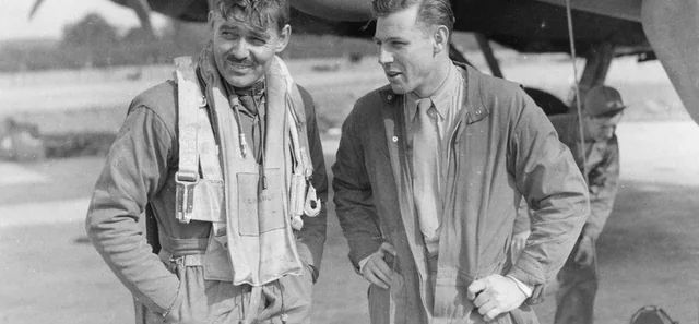 Capt. Clark Gable (left) and co-pilot Lt. Col. Robert W Burns, both of the Boeing B-17 'The Duchess,' discuss their daylight bombing raid.